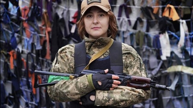 Ukrainian soldier Sarnatska stays with an assault rifle